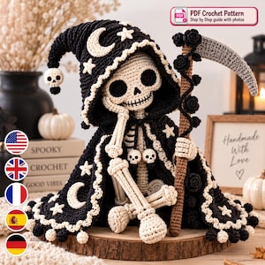 May include: A crocheted skeleton figure wearing a black hooded cloak decorated with white crescent moons and stars. The figure holds a scythe with a grey blade and black rose accents. A small skull charm hangs from the hood and the cloak ties.