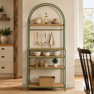 May include: A tall, arched metal baker's rack with a sage green frame and four light wood shelves. It features a horizontal bar with four hanging hooks for kitchen utensils, a towel, and multiple open storage levels for bowls, jars, and a basket.