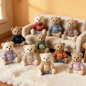 May include: A collection of ten small bear figurines, each wearing a textured knit sweater in various colors including red, blue, brown, green, purple, beige, orange, and pink. Each bear has a small metal loop attached to the top of its head.