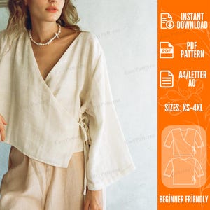Puede incluir: Una blusa cruzada de color beige con mangas largas y anchas y un cierre de lazo lateral. El patrón digital incluye el texto: INSTANT DOWNLOAD, PDF PATTERN, A4/LETTER A0, SIZES: XS-4XL y BEGINNER FRIENDLY. Diseño con cuello en V y ajuste holgado.