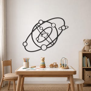 May include: A black metal wall art piece featuring a stylized solar system design with multiple circular orbits and spherical planets connected by thin lines, creating a geometric representation of celestial bodies in space.