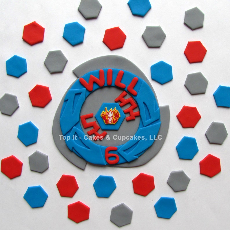 May include: A blue and gray cake topper with the words "Will Turn 6" and a red and yellow cartoon character. The topper is surrounded by gray, red, and blue hexagonal decorations.