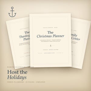 May include: Three cream-colored paper planners with dark blue text. The center planner is titled The Christmas Planner. The left planner is The Thanksgiving Planner, and the right is Family Center. Each features an anchor icon and text.