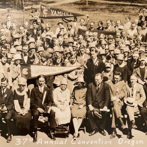 May include: A black and white photo of a large group of people gathered for the 37th Annual Convention of Oregon. The people are holding banners that read "Union Yamhill" and "Washington County".