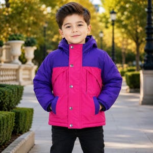 May include: A hooded jacket featuring a color-blocked design with a bright pink center panel and sleeves and upper chest sections in deep purple. The jacket includes a front placket with four visible silver-toned metal snap buttons.