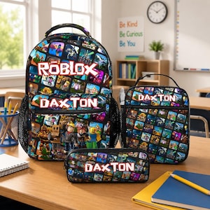 May include: A backpack, lunch bag, and pencil case set featuring a colorful Roblox-themed grid pattern. Each item displays the name DAXTON in white block letters, with the backpack also featuring the Roblox logo in red and white text.