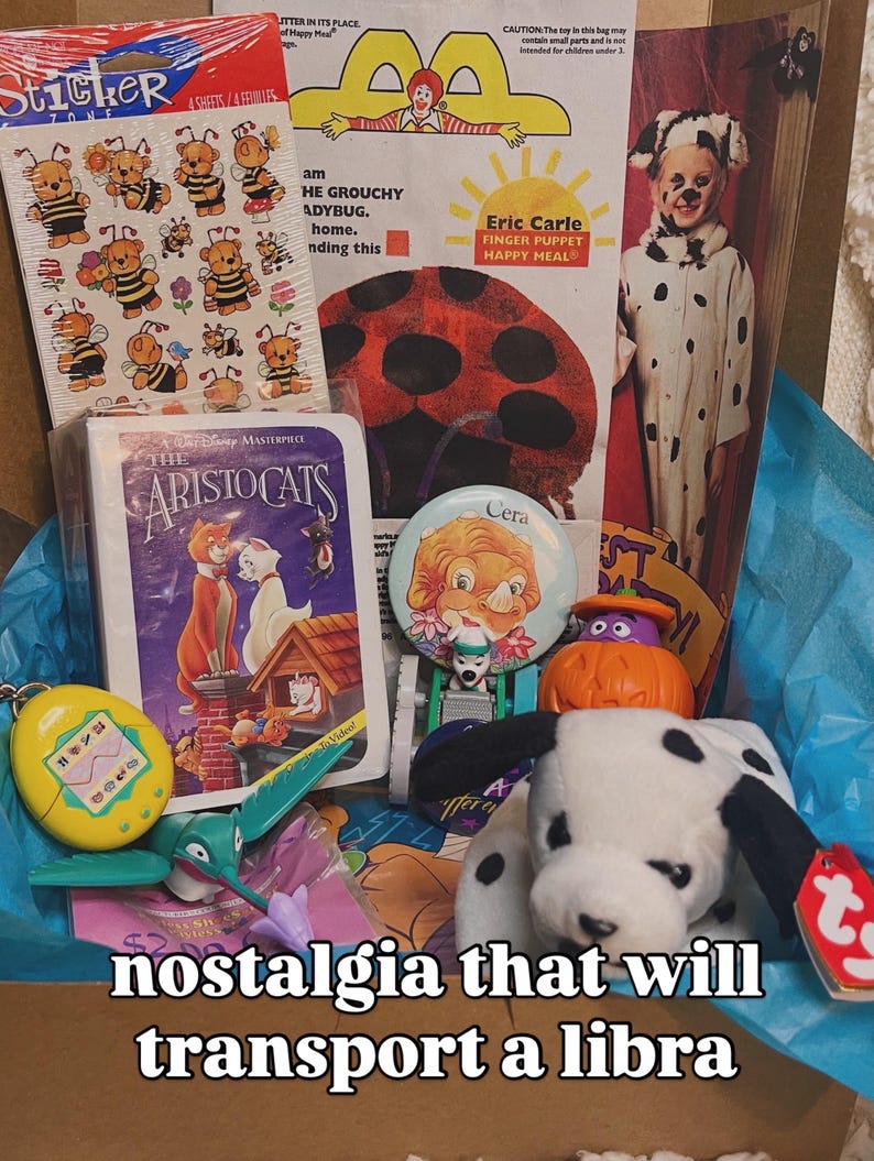 May include: A collection of vintage toys and memorabilia including a sheet of bee stickers, a McDonald's Happy Meal bag, a VHS case for The Aristocats, a Cera button, a small pumpkin figure, a yellow digital pet, and a plush dalmatian dog toy.