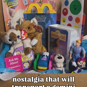 May include: A collection of 1990s memorabilia including a Fun Times magazine, a McDonald's Happy Meal box, a Pocahontas VHS tape, Ty plush toys, a Blackberry promotional card, and various plastic character figurines nestled in blue tissue paper.