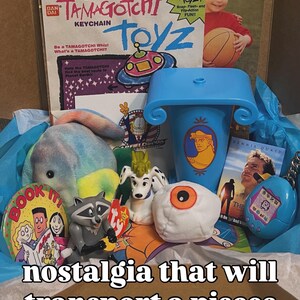 May include: A collection of vintage items including a McDonald's Happy Meal Tamagotchi bag, a blue Hercules cup, a plush toy, a raccoon figure, a white dog figurine, a plush eyeball, a Dennis Quaid movie card, and a blue Tamagotchi keychain.