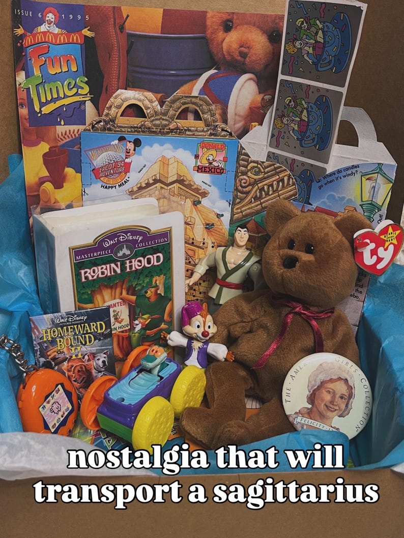 May include: A collection of 1990s memorabilia including a Fun Times magazine, a Disney Robin Hood VHS, a Homeward Bound II movie case, a brown Ty Beanie Baby bear, a small plastic toy car, a Tamagotchi, and a round American Girls Collection pin.