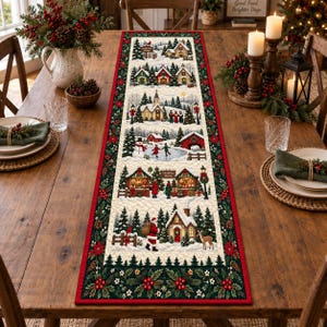 May include: A rectangular fabric table runner featuring a series of winter village scenes with snow-covered houses, a church, a frozen pond with skaters, a Christmas market, and Santa Claus, all bordered by a dark green holly and red berry pattern.