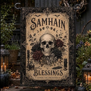May include: A rectangular garden flag featuring a central human skull surrounded by dark red and black roses, crystals, and candles. The text reads SAMHAIN BLESSINGS and HONOR THE ANCESTORS, with a moon phase cycle and spider web border design.