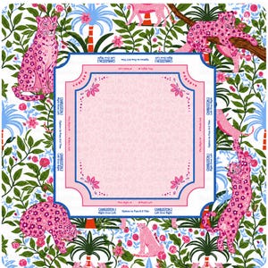 May include: A square mahjong mat featuring a central light pink area with a subtle leopard print pattern, surrounded by a white border decorated with pink leopards, green foliage, and blue palm trees, including printed game instructions.