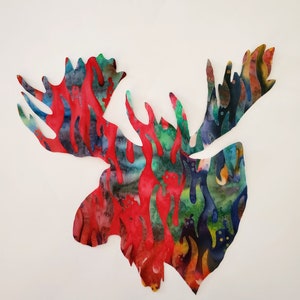 May include: A red, blue, and green moose head silhouette with a tie-dye pattern.