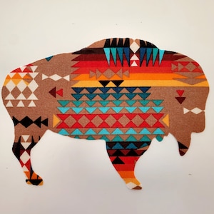 May include: A brown silhouette of a buffalo with a geometric pattern in shades of red, orange, blue, and white.