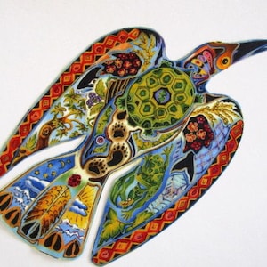 May include: A colorful, stylized raven illustration with intricate patterns. The artwork features a variety of colors, including red, orange, blue, green, and yellow. The raven's wings are spread, and the design incorporates floral and geometric elements.