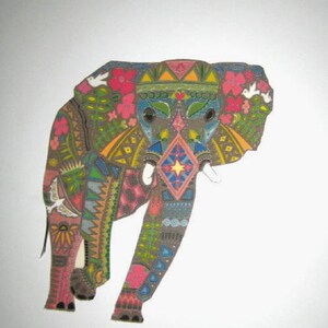May include: A colorful, patterned elephant illustration. The elephant is decorated with geometric shapes, flowers, and birds in shades of brown, pink, blue, and yellow. The design is intricate and detailed, with a folk art aesthetic.