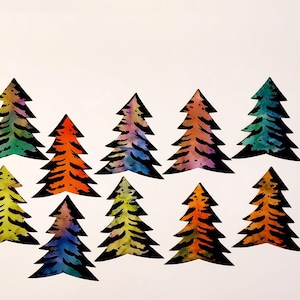 May include: Watercolor painting of ten stylized Christmas trees. Each tree is a different color, including yellow, orange, blue, and green, with black tiger stripe patterns. The trees are arranged on a white background.