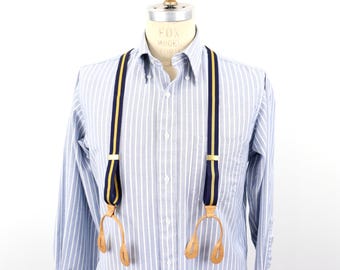 Paski skórzane z lat 60. XX wieku z gumką w kolorze niebieskim, żółtym i złotym, z brązowymi, zapinanymi na guziki końcami / Rozmiar męski S