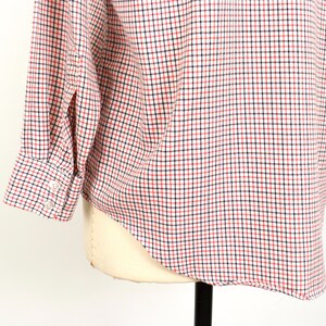 May include: A long-sleeved button-down shirt with a red and blue plaid pattern. The shirt is made of a soft, lightweight fabric and has a classic fit.