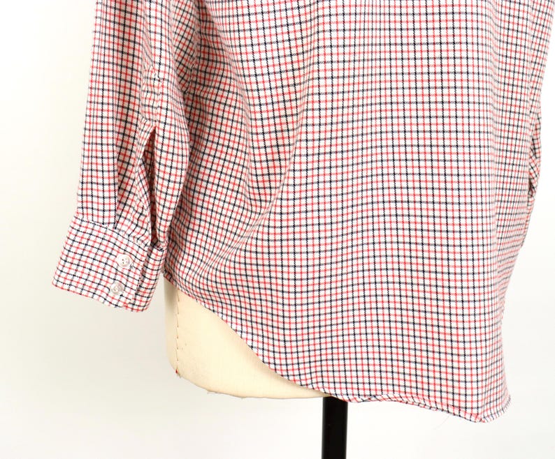May include: A long-sleeved button-down shirt with a red and blue plaid pattern. The shirt is made of a soft, lightweight fabric and has a classic fit.