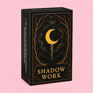 May include: A black rectangular tarot deck box titled Shadow Work with gold lettering. The front features a yellow crescent moon, a single eye, and bare tree branches. The side text reads A 78-CARD TAROT DECK, GUIDEBOOK & REFLECTOR.