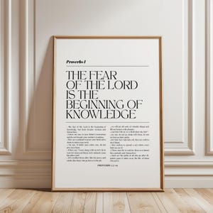 May include: A framed wall art print featuring the text of Proverbs 1 from the Bible. The design includes the title Proverbs 1, the verse The Fear of the Lord is the Beginning of Knowledge in large font, and smaller text of verses 7 through 19.