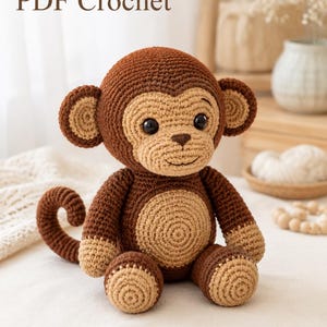 May include: A brown and tan crochet monkey toy with black plastic eyes, a curled tail, and a light tan face and belly. The text PDF Crochet is visible in the upper left corner, and the text AmiLoomStudio is in the lower right corner.