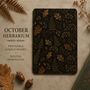 May include: A rectangular Kindle insert featuring a dark background with a repeating pattern of golden-brown oak leaves, ferns, and acorns. The text reads OCTOBER HERBARIUM, PRINTABLE KINDLE INSERT, and DIGITAL DOWNLOAD in a serif font.