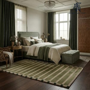 May include: A rectangular area rug featuring a pattern of alternating olive green and cream-coloured stripes. The rug is positioned on a dark wood floor in a bedroom setting, complemented by a green upholstered bed, matching curtains, and a bench.