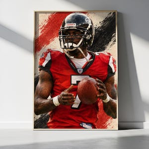 May include: A framed poster featuring a football player wearing a red jersey with the number 7, a black helmet, and white wristbands. The player is holding a brown football against a background of abstract red and black brushstrokes.
