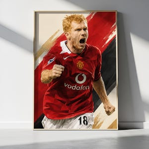May include: A framed digital art print featuring a red-haired soccer player in a red jersey with a white collar, a Vodafone logo, and the number 18 on white shorts. The player is shown with a shouting expression, set against a red and black background.