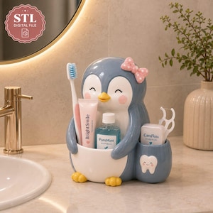 May include: A blue and white penguin-shaped bathroom organiser featuring a pink polka-dot bow, holding a toothbrush, a tube of BrightSmile toothpaste, a bottle of PureMint mouthwash, and a container of CareFloss dental floss with a tooth icon.