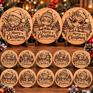 May include: A collection of round wooden coasters featuring laser-engraved illustrations of Highland cows wearing winter hats and scarves, surrounded by pine trees and gifts, with the text Merry Christmas inscribed on each piece.