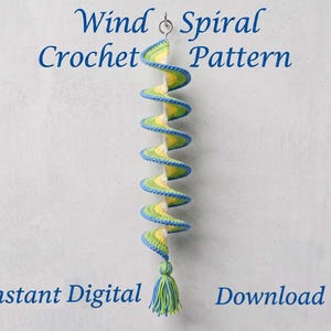 May include: A crochet wind spiral hanging decoration featuring a blue, green, and yellow color gradient with a tassel at the bottom. The text Wind Spiral Crochet Pattern and Instant Digital Download is displayed in blue font around the object.