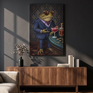 May include: A rectangular wall art print featuring a toad wearing a navy blue pinstripe suit, a purple shirt, and round brown glasses. The toad stands beside a green gaming table with a red cocktail, a glass decanter, and several gold coins.