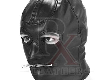 May include: A black leather hood featuring a full-face design with stitched seams, two eye openings, and a horizontal silver-tone metal zipper closure positioned across the mouth area. The surface displays a smooth texture with visible stitching details.
