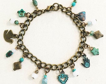 Turquoise Antique Brass Charm Bracelet with Antique Brass Turquoise Patina Charms and Gemstones.