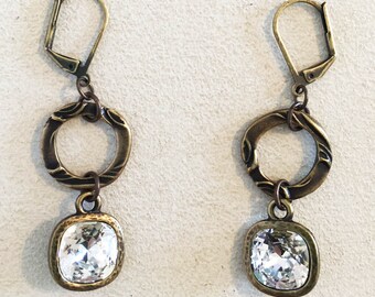 Sparkly Tierra Cast Crystal Charm on Brass Oxide Pewter Flora Rings Dangling from Antique Brass Lever Back Earrings.