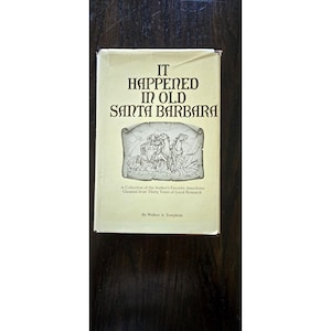May include: A hardcover book titled It Happened in Old Santa Barbara by Walker A. Tompkins. The cream-colored dust jacket features dark brown text and a central black and white line drawing of a horse-drawn carriage on a scroll-like background.