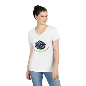 May include: A white V-neck t-shirt featuring a graphic of a coiled snake with blue and green scales. Below the snake, the text "Bridgett Nelson Horror" is printed in a simple, dark font. The shirt has short sleeves and a standard fit.