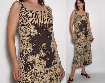 May include: A brown and beige midi dress with a floral print. The dress has a square neckline and thin straps.