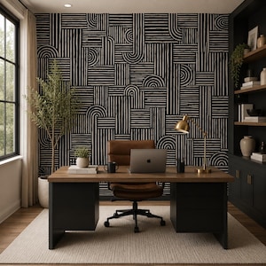 May include: A home office featuring a dark wood desk with black pedestals, a brown leather swivel chair, and a laptop. The wall is covered in black and white wallpaper with a geometric pattern of vertical lines and semi-circles.