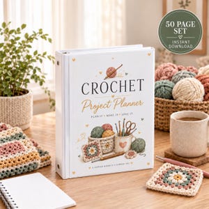 May include: A white three-ring binder titled Crochet Project Planner with illustrations of yarn balls, crochet hooks, and a granny square. The cover text reads Crochet Project Planner, Plan It Make It Love It, and A Happier Maker Is A Happier You.