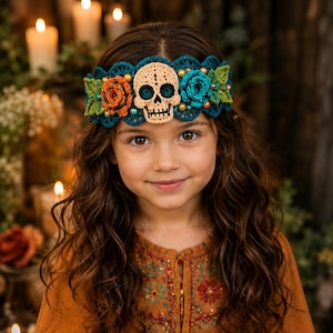 May include: A teal crochet headband featuring a central beige skull motif, flanked by orange and teal crocheted roses, green leaves, and small round beads. The intricate lace-like border design incorporates floral elements and decorative accents.