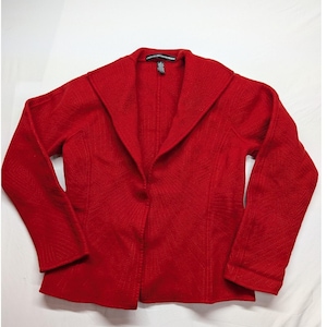 May include: A bright red long-sleeved jacket with a wide collar and a textured fabric finish. The garment features a single-button closure at the front and a black interior neck label with the text Linda Allard Ellen Tracy.