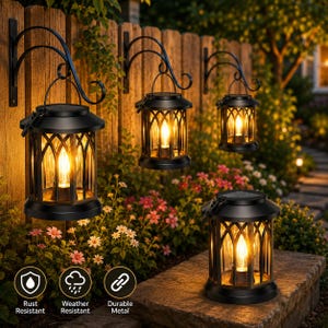 May include: Three black metal lanterns with arched wall brackets and one matching lantern sitting on a stone surface. Each lantern features a gothic-style frame with clear glass panels and a warm glowing light inside, plus solar panels on top.