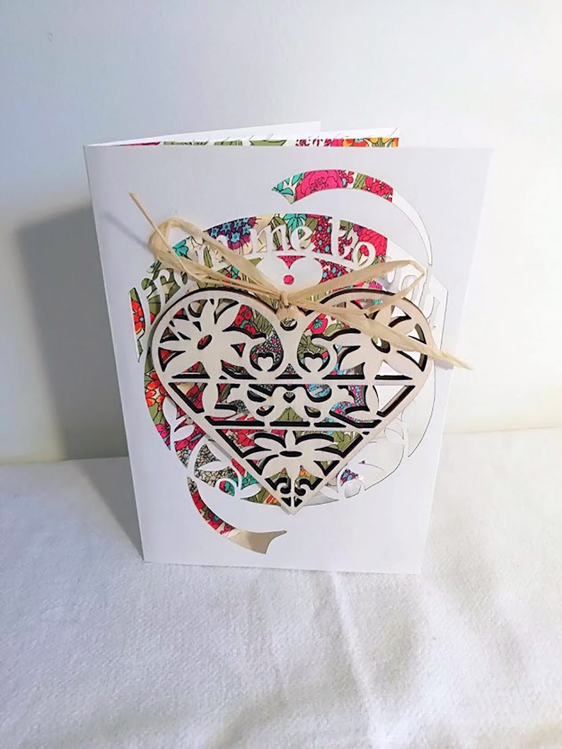 Paper cut card with love heart token