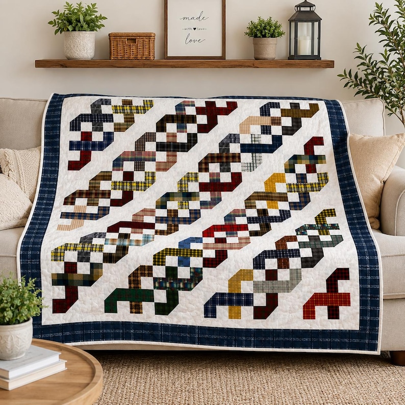 May include: A quilt featuring a white background with diagonal, interlocking ribbon patterns made of various plaid fabrics in shades of red, blue, yellow, green, and brown. The quilt is finished with a dark blue plaid border around the edges.