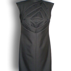 May include: A black sleeveless dress with a geometric design on the bodice.